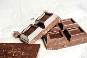 A close-up shot of gourmet dark chocolate bars on a white background. Perfect for food photography enthusiasts.